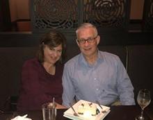 Couple sitting next to each other at a restaurant. 