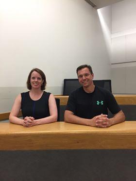 Couple sitting next to each other in a lecture room.