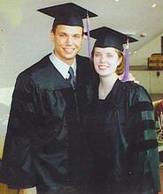 Couple in caps and gowns at graduation.