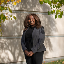 JD Emani Marshall-Loving standing outside of the Boyd Law Building in the fall