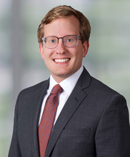 Law firm head shot of Iowa Law alum Matthew Strand in a suit.